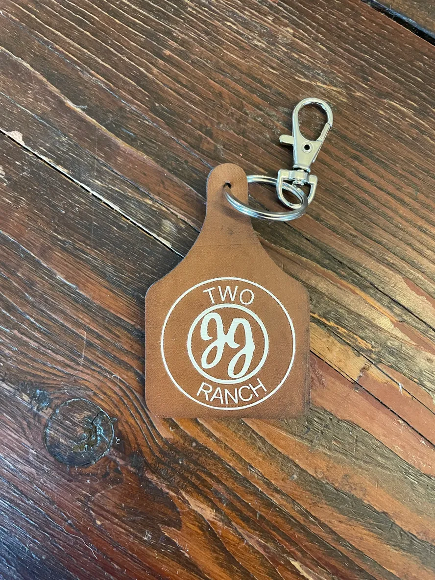 Leather keychain on wooden surface.