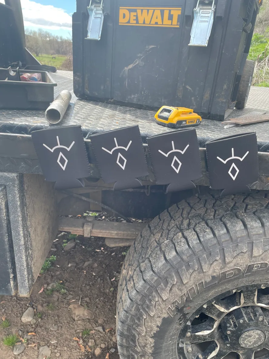 Truck bed with tools and decorated panels.