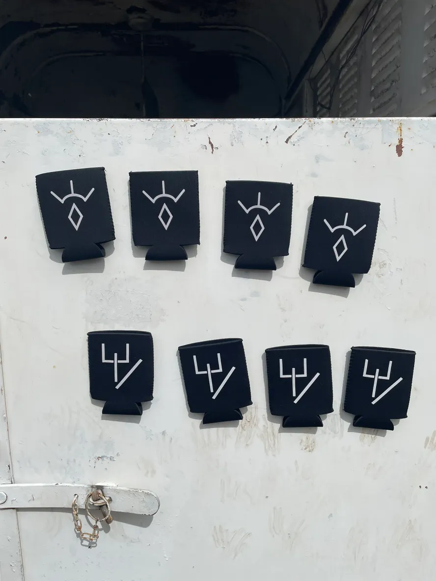 Black holders with white abstract symbols displayed.