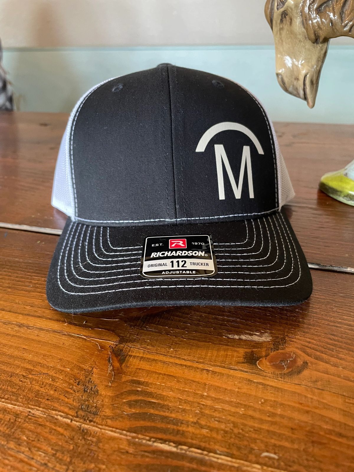 Black and white cap with letter "M".