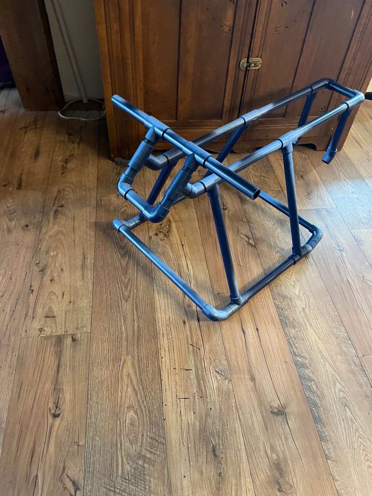 Large blue roping dummy toy for kids on a wooden floor