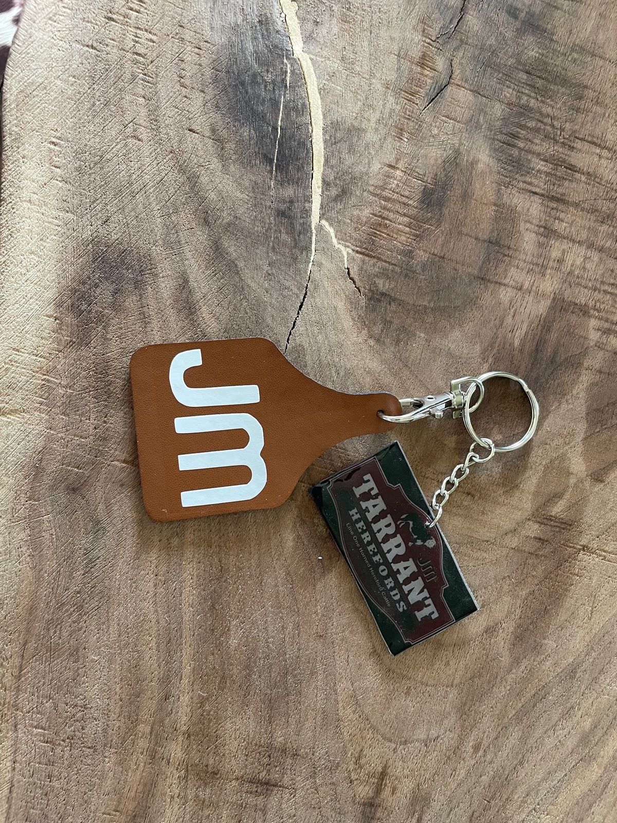 Keychain with JM and Tirana logos.