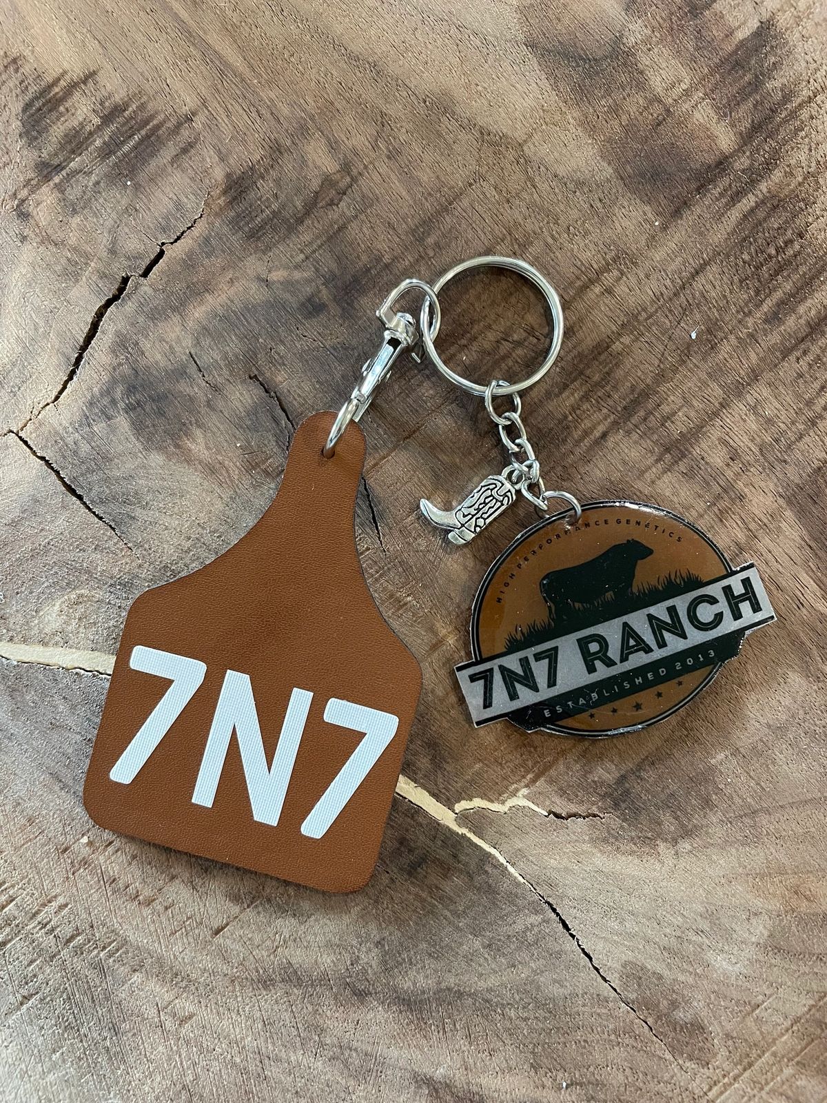 7N7 Ranch keychain on wooden surface.