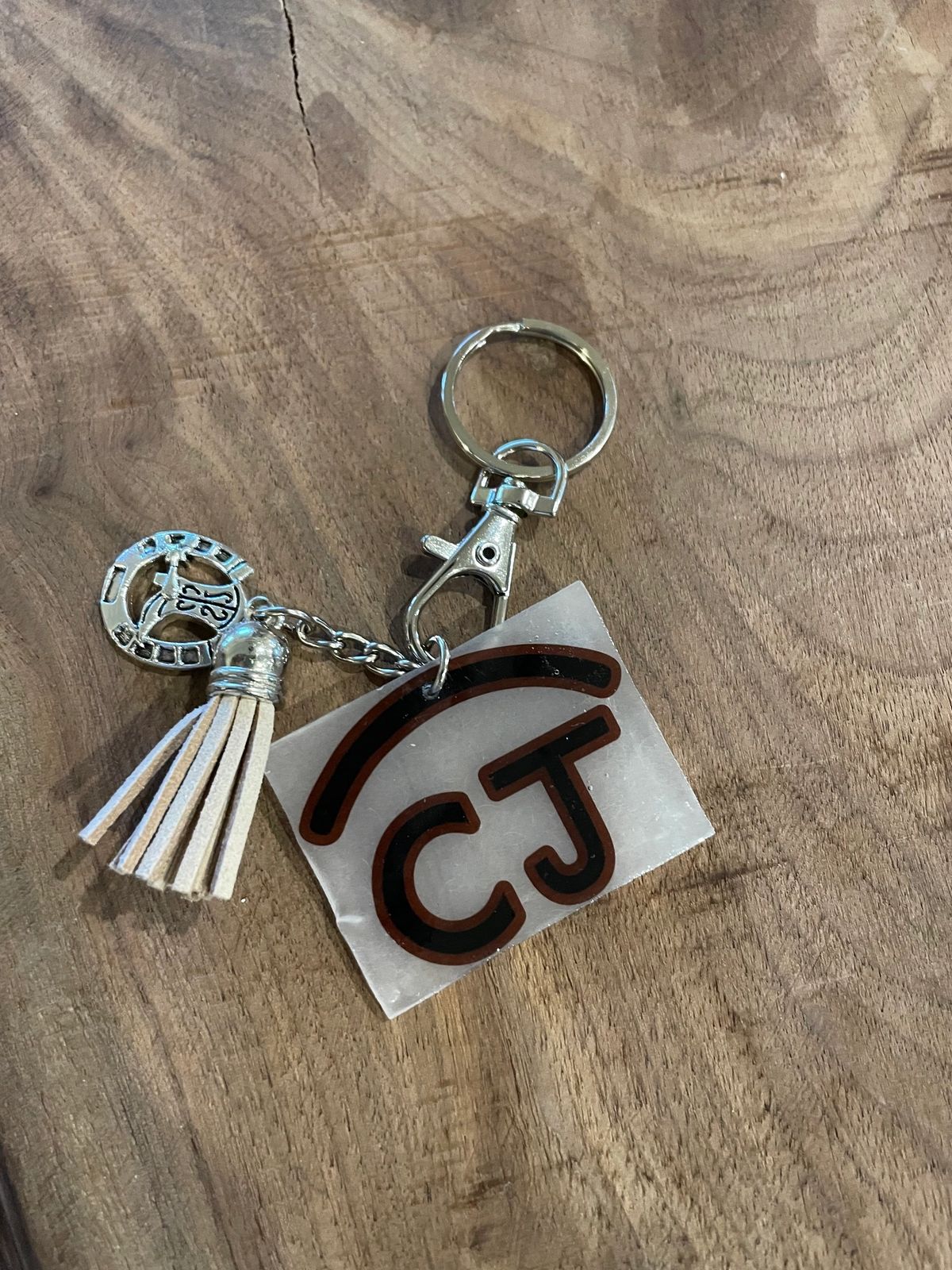 Keychain with tassel and abstract design.