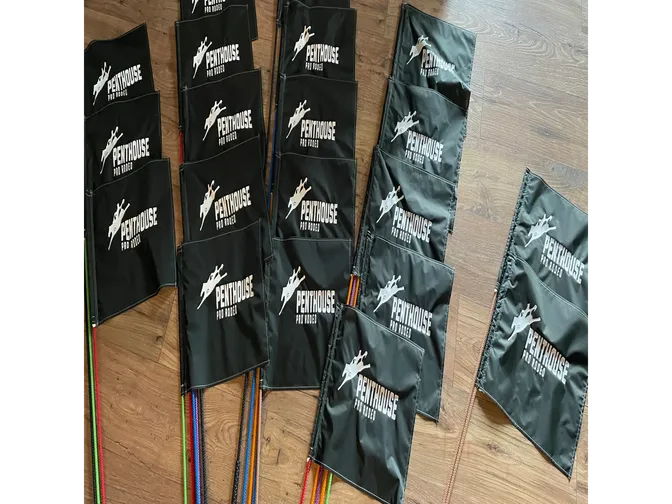 Black flags with Penthouse logo on floor.